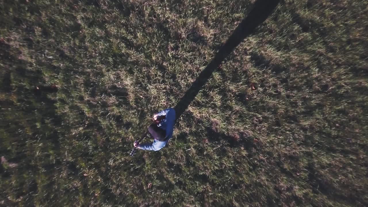 Aerial view of a person standing in a field of grass