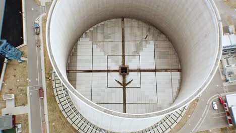 Close-drone-flight-over-a-giant-cooling-tower-of-an-coal-power-plant-in-central-Europe-with-view-inside