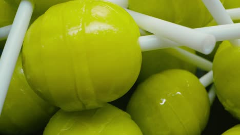 green lollipop stick candies spinning. broll detail shot. close up.