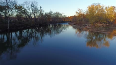 fast moving aerial shot flying over elkhorn creek at sunset in the fall