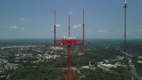 two tall radio towers overlooking city