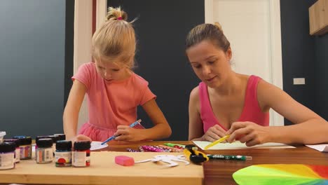 mother and daughter doing arts and crafts together