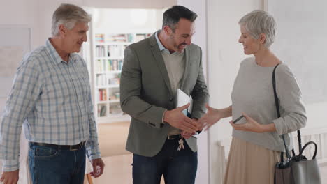 real estate agent showing mature couple new house presenting property investment happy clients shaking hands with realtor successfully purchasing home 4k footage