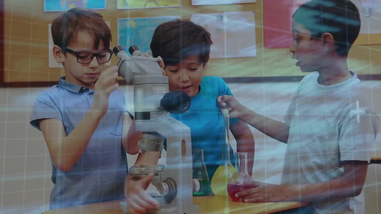 Gripping focus knobs glasses boy leaning into microscope with peers exchanging flasks for lab study