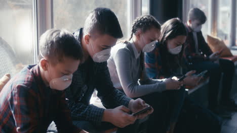 children waiting in a line wearing masks