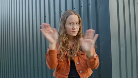 young woman emphatically declining with expressive gestures