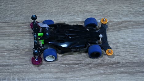Zooming out on a Tamiya Mini sports car that is placed on a table in a shop in Bangkok, Thailand