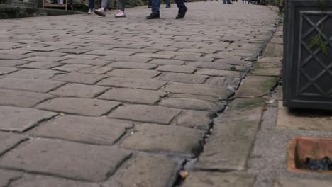 shoppers browsing in cobbled street in yorkshire village haworth low shot