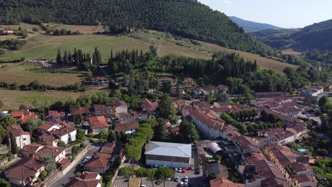 Ascending-aerial-overview-of-Molin-del-Piano,-ancient-town-near-Arno-river-valley