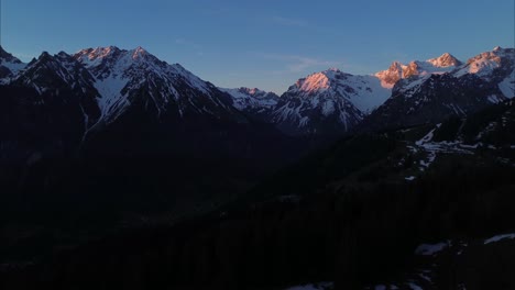 Aerial-View-Above-Mountain-Landscape-with-Snow-covered-Summits-in-Morning