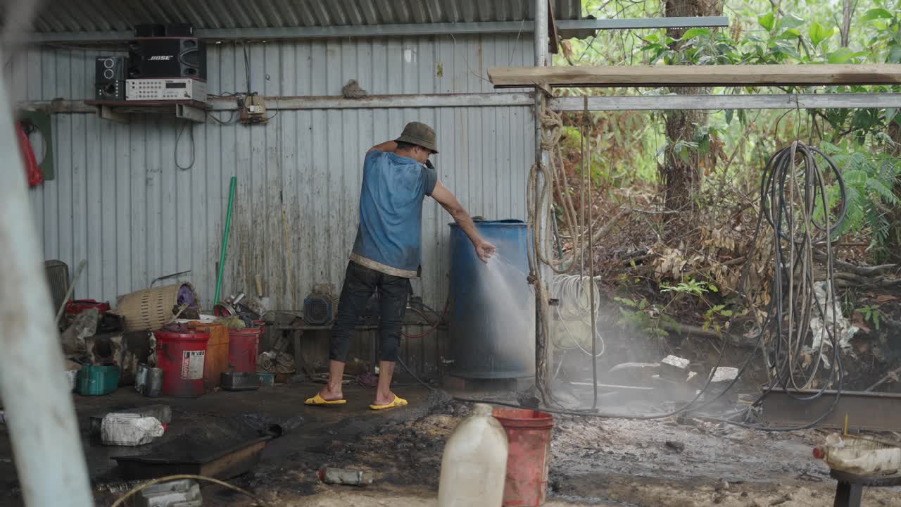Worker Cleaning a Workshop