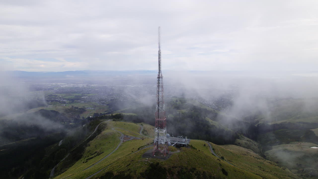 Aerial view circling the radio tower on top of Sugarloaf mountain in New Zealand