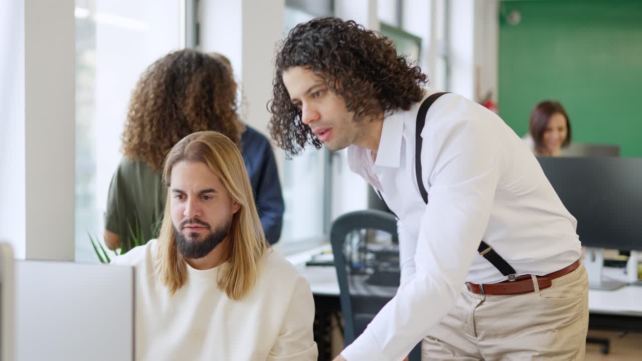 Man helping a hand to a colleague in a coworking