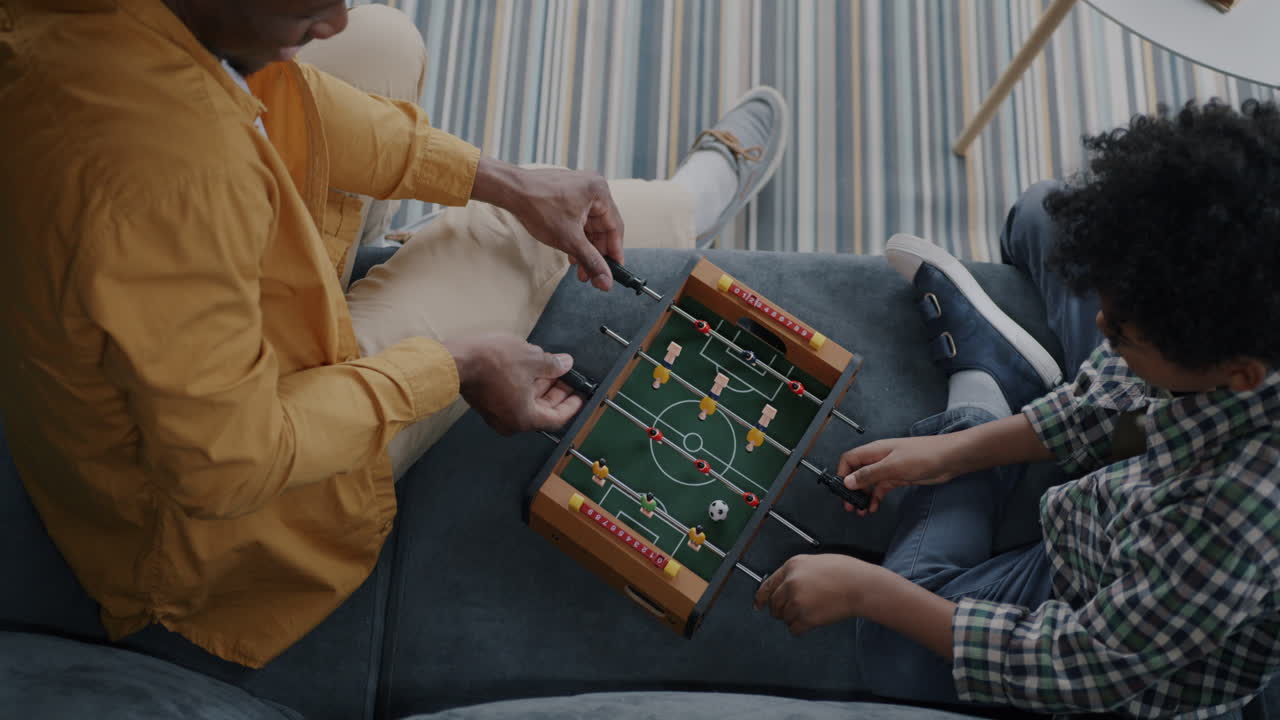 Father and Son Playing Table Football