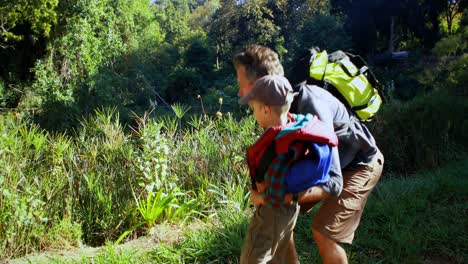 father and son hiking in the forest