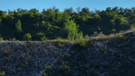 motocross rider on a hillside trail