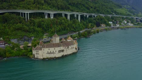 chillon castillo de la ciudad suiza está volviendo y hay muchos árboles alrededor del castillo, y teje en el agua