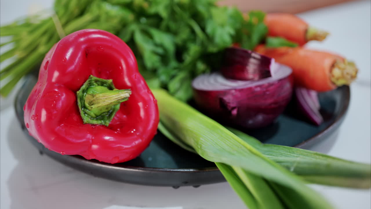 Close up of different vegetables on a plate in the kitchen