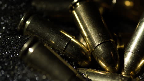 9×19mm parabellum bullets sitting on gunpowder dust pile, macro detail closeup