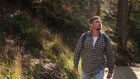 man hiking in autumn forest