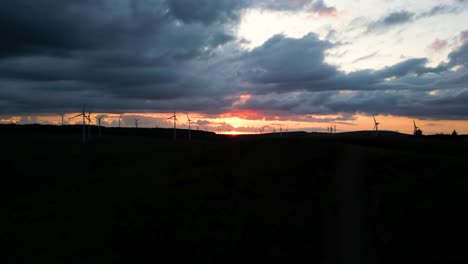 aerial footage of windfarm at sunset