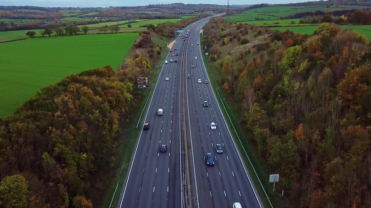 Drone shot above M1 Motorway in the UK around Junction 29 looking north tilting panning up bottom to top