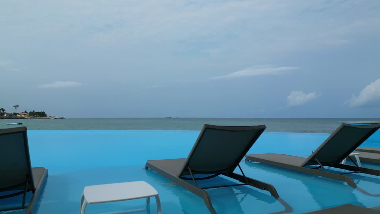 View of chairs and a table in an infinity pool, São Tomé,Africa