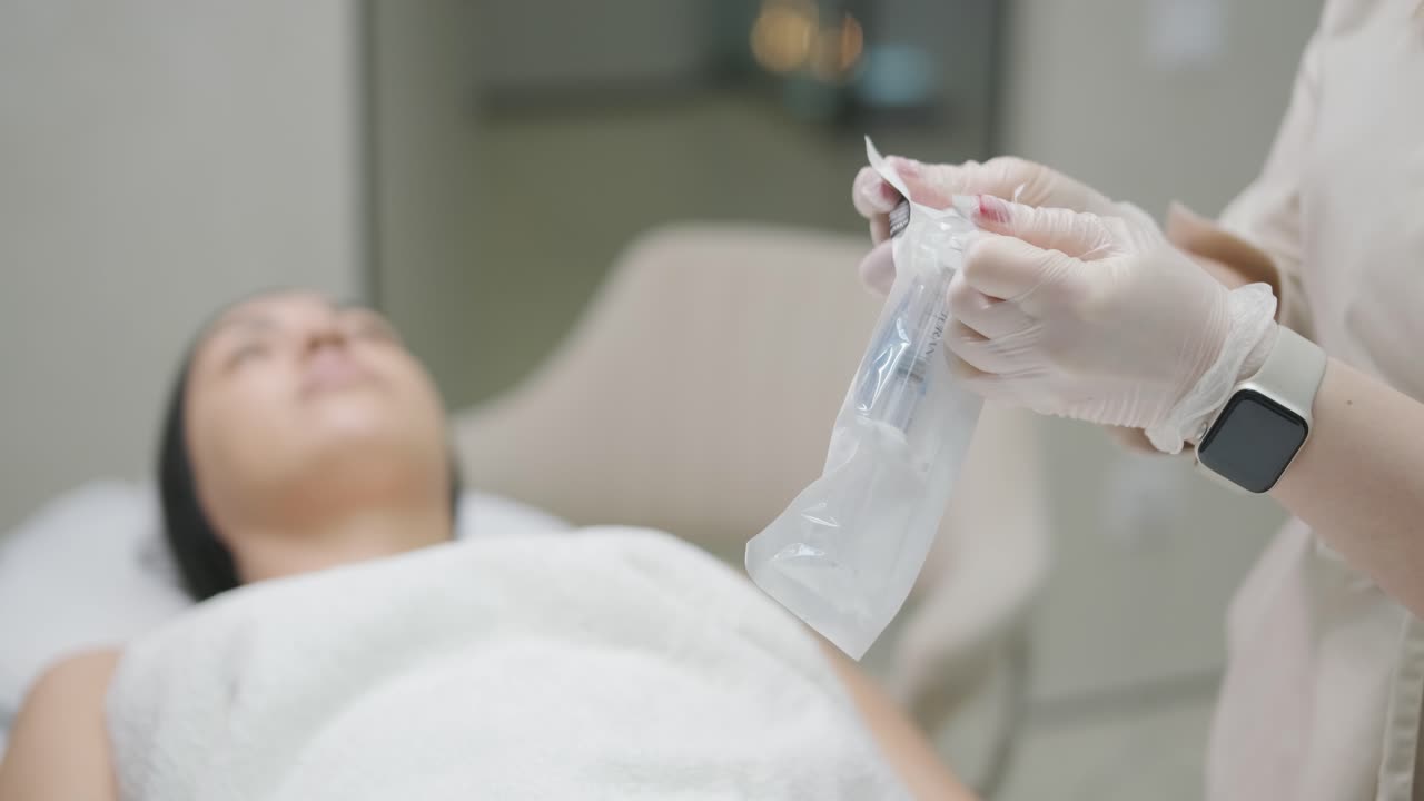 현대 화장품 클리닉에서 보리넘 치료를하는 여성 전문 화장품 전문가는 얼굴 피부를 재생시키기 위해 보리 독소를 주사합니다. 매력적인 여성 환자 주름을 부드럽게합니다.