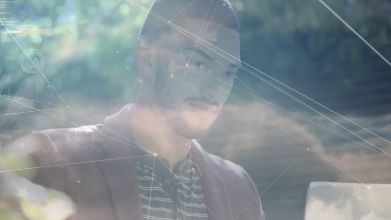 Man interacting with tech data outdoors, showing floating network lines, graphs and cloud visuals