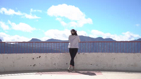 woman looking at mountains landscape at viewpoint in artenara, gran canaria, spain