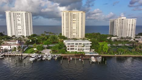 yacht and boats at private pier with mansion and villas in background