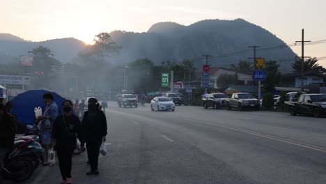 pedestrians and vehicles crossing busy intersection