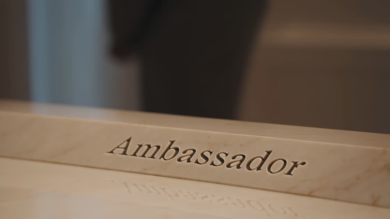 Engraved 'Ambassador' Sign on Marble Surface