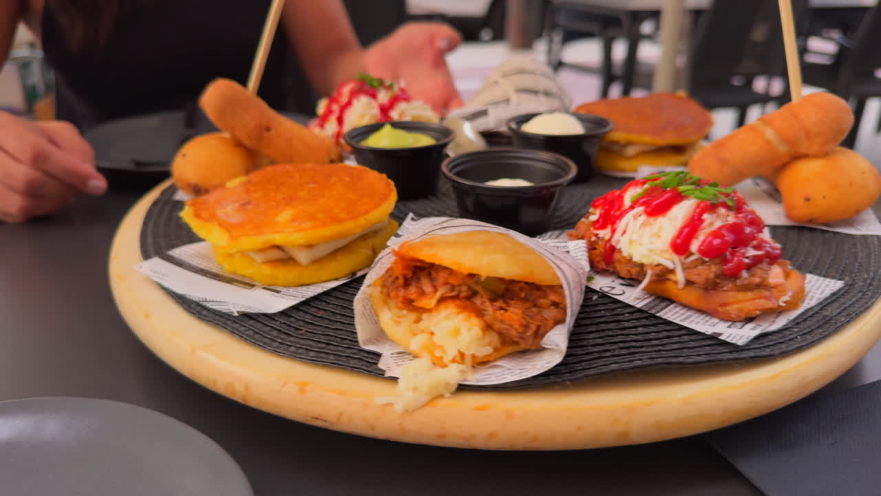 Assorted platter with traditional Venezuelan dishes such as empanadas, tequeños, cachapas and patacones served at a restaurant