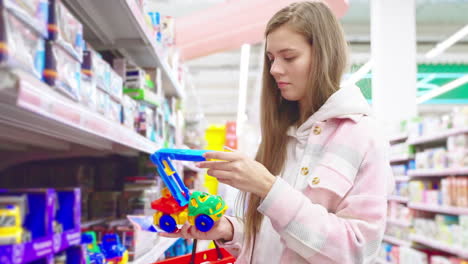 woman shopping for toys in a grocery store