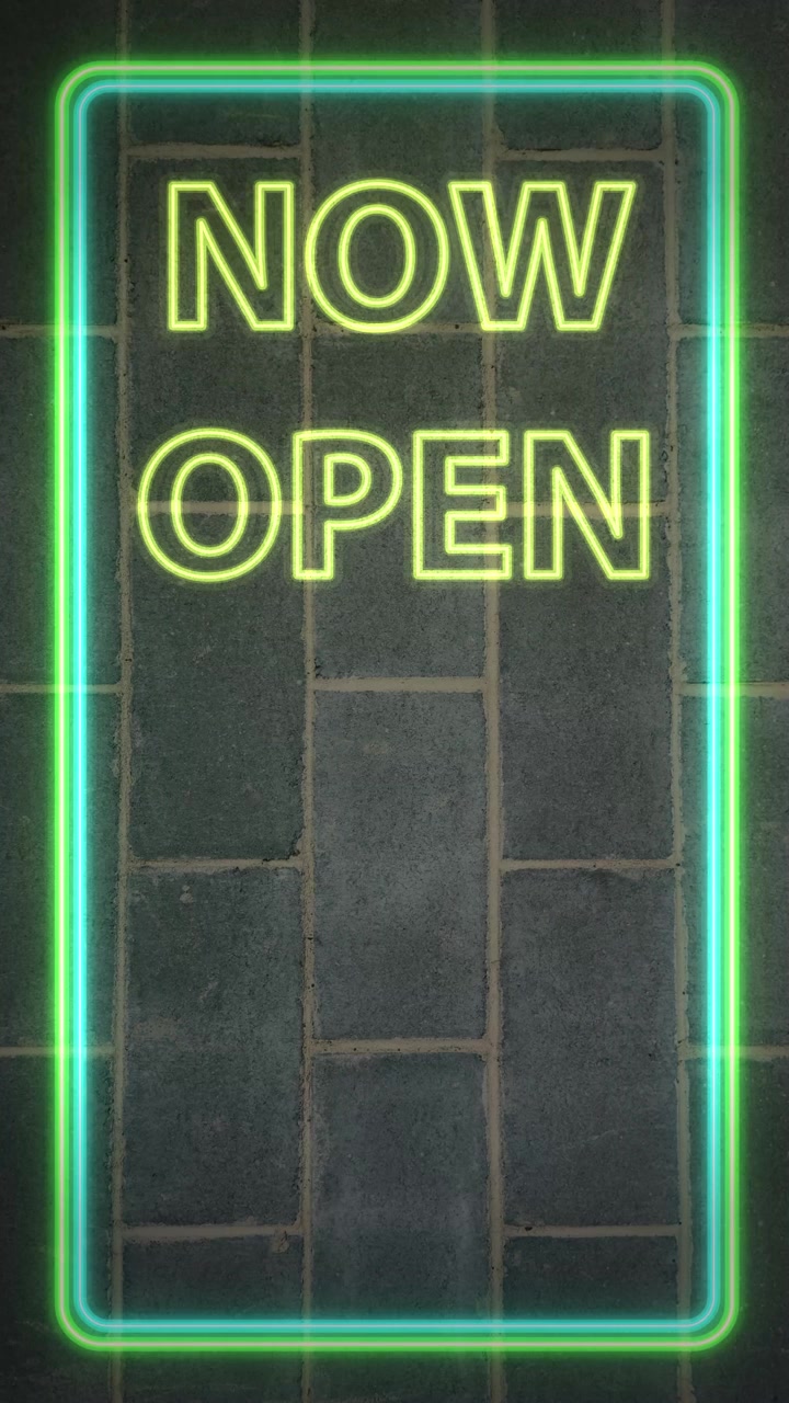 Glowing green neon sign flashes on dark brick wall in a vertical loop animation.
