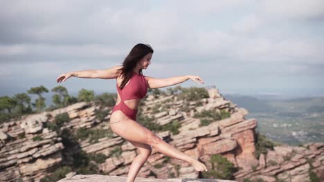 woman balancing on a cliff
