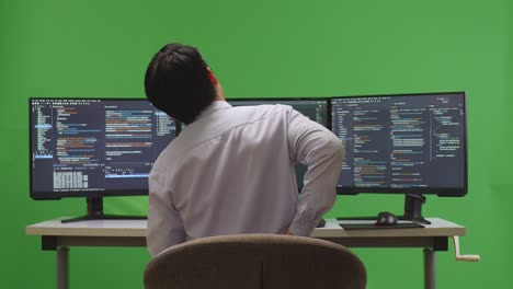 programmer working on multiple monitors