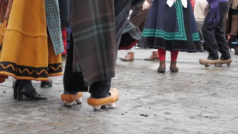 traditional dancers in wooden shoes perform in plaza de sol during madrid's transhumance festival