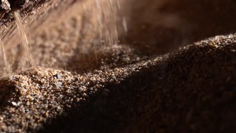 close up of a industrial machine dropping sand used for landscaping, natural material.
