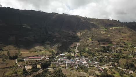 huasmin, a rural village in cajamarca, peru. the photo showcases the village surrounded by agricultural fields and rugged highland terrain, depicting the peaceful lifestyle of the peruvian countryside