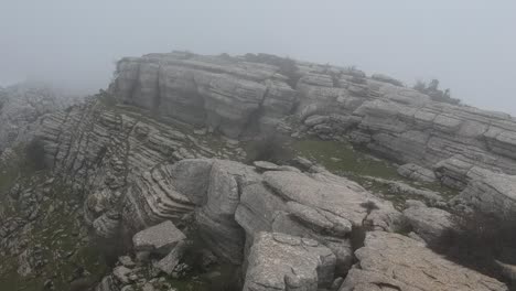 aerial views of a mountain with thick fog on a winter day