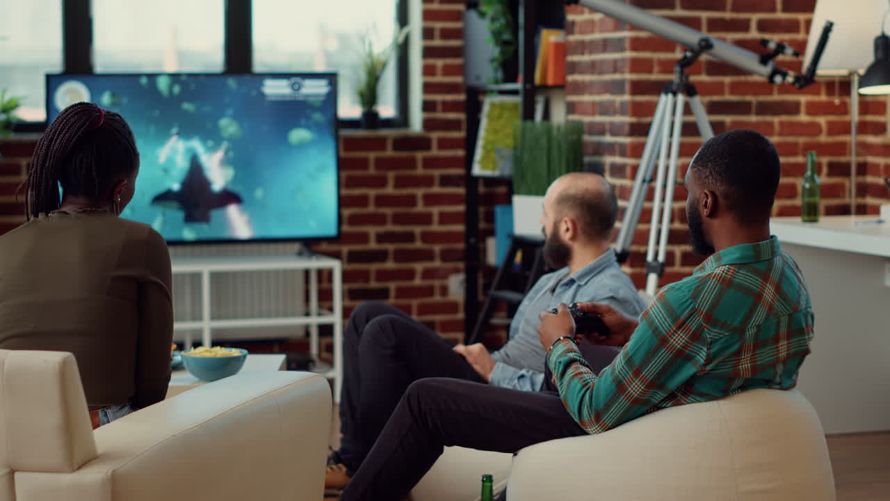 Happy people playing video games and winning competition