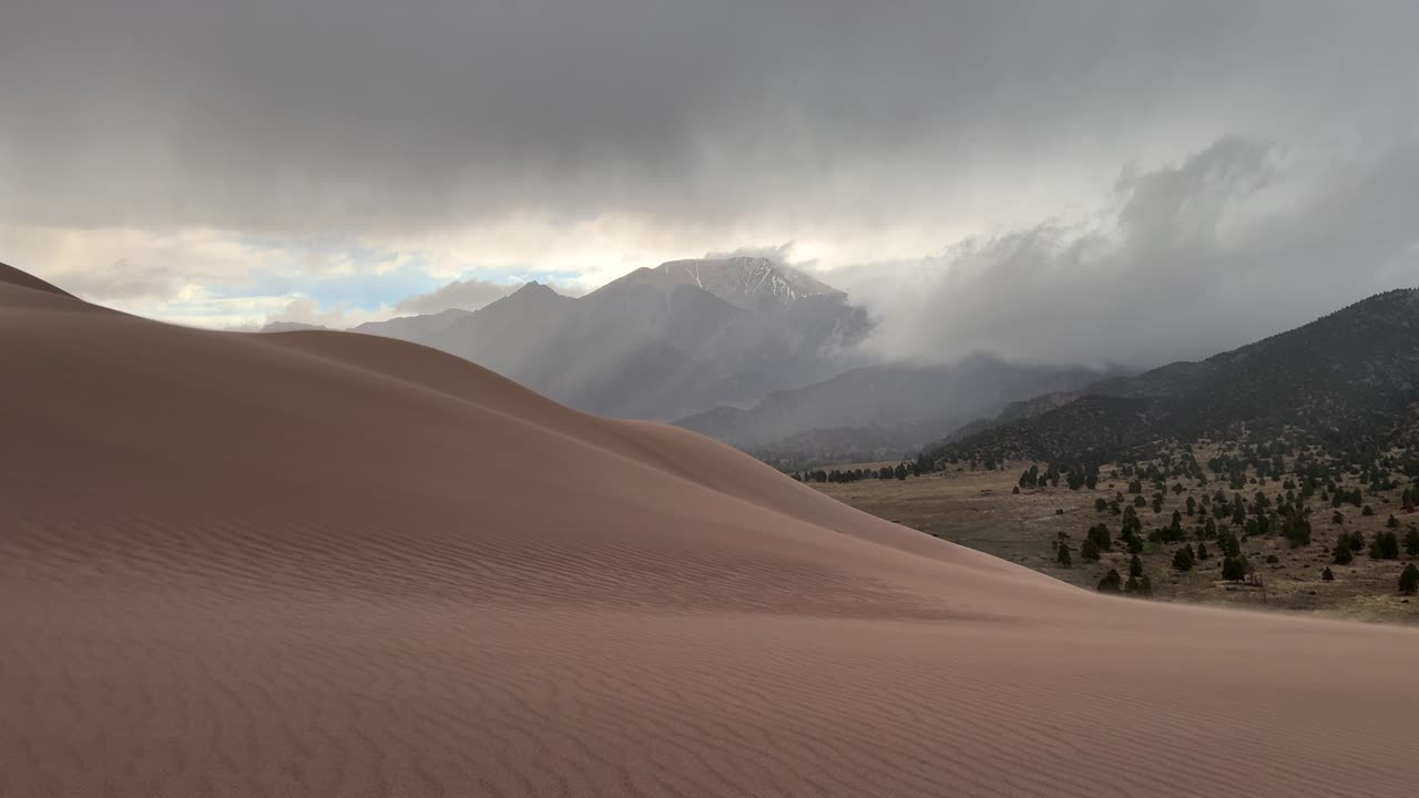 Windy Great Sand Dunes National Park Spring summer stormy foggy cloudy raining mist Crestone Needle peak Colorado Sangre de Cristo range Rocky Mountains magical large amounts of sand dune hills pan