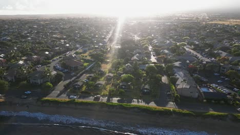 morning sunrise aerial rotates over coastal kihei city on maui, hawaii