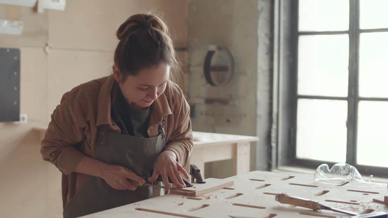 Young Female Joiner Working in Workshop