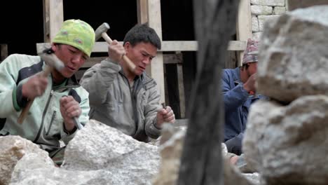 pan of stone masons chiseling