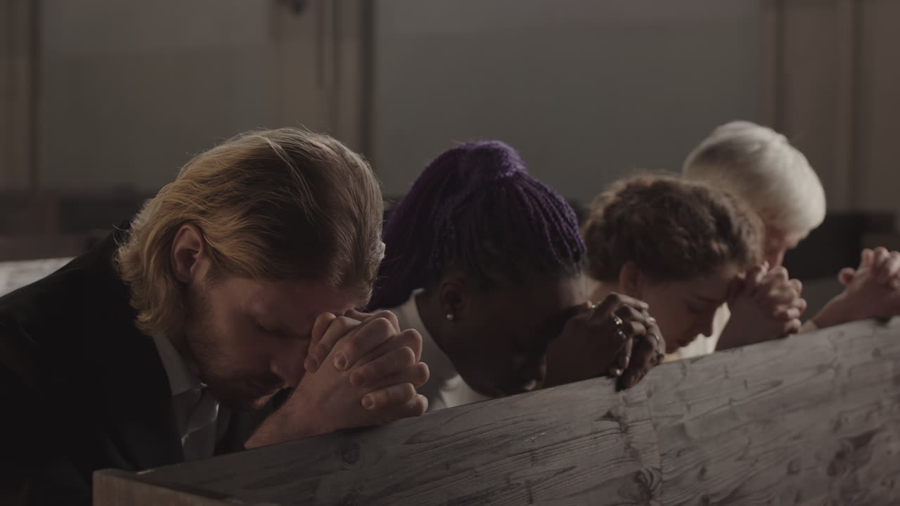 Four People Praying in Catholic Church