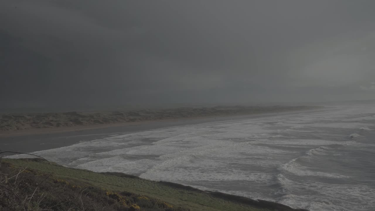 Stunning landscape in the coast of devon england uk. Wild sea with lot of waves and beach in the distance