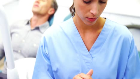 Female-nurse-using-digital-tablet-in-clinic